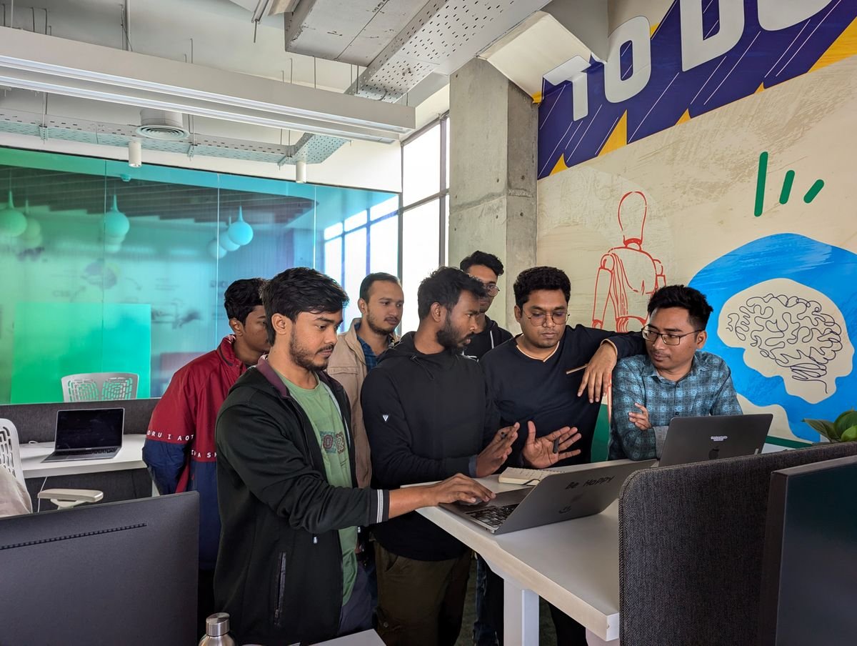 Creative team collaborating around a laptop